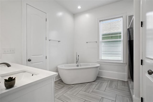 bathroom with a bathtub and vanity