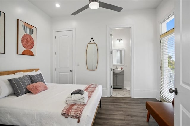 bedroom with dark hardwood / wood-style flooring, sink, connected bathroom, and ceiling fan