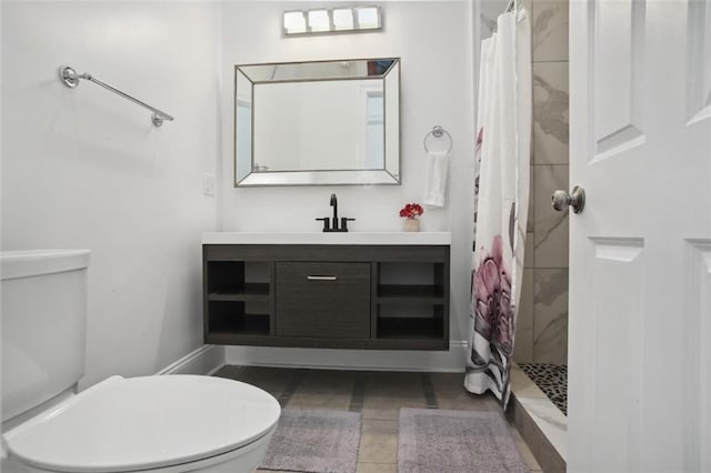 bathroom featuring a shower with shower curtain, tile patterned floors, vanity, and toilet