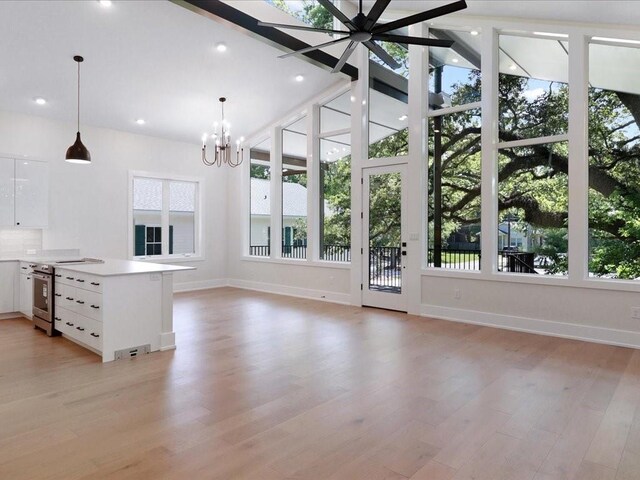 unfurnished living room featuring beamed ceiling, high vaulted ceiling, and light hardwood / wood-style floors