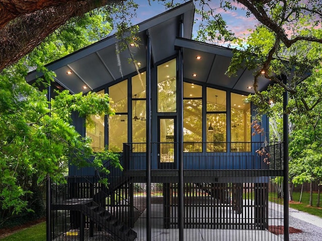 exterior space featuring a sunroom and stairway