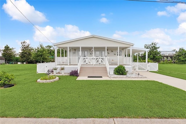 view of front of home with a front yard and covered porch