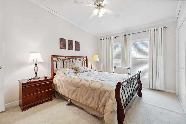 carpeted bedroom with crown molding, a closet, and ceiling fan