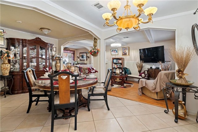 dining area with ornamental molding, light hardwood / wood-style flooring, and a chandelier