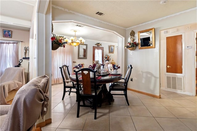 tiled dining space featuring crown molding, a textured ceiling, and a chandelier