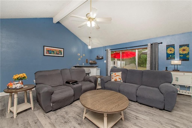 living room with light hardwood / wood-style flooring, lofted ceiling with beams, and ceiling fan