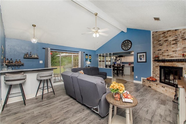 415 Driftwood Cir, Slidell, LA 70458 - living area featuring wood finished floors, a ceiling fan, beam ceiling, a fireplace, and baseboards