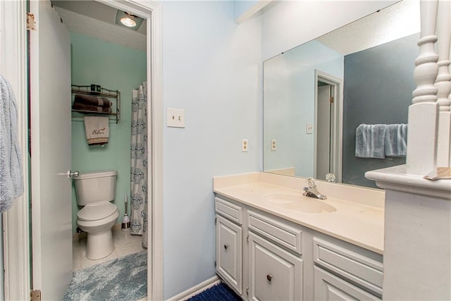 bathroom with vanity, toilet, and tile patterned flooring