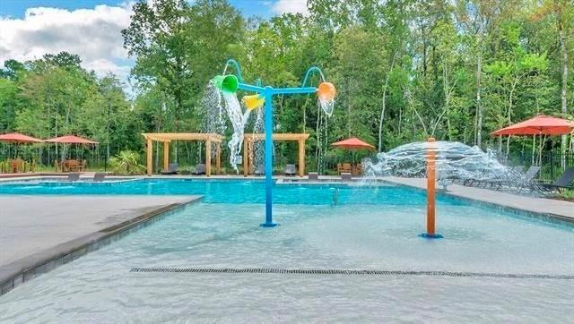 view of swimming pool with pool water feature