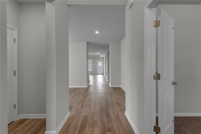 hallway with light hardwood / wood-style floors