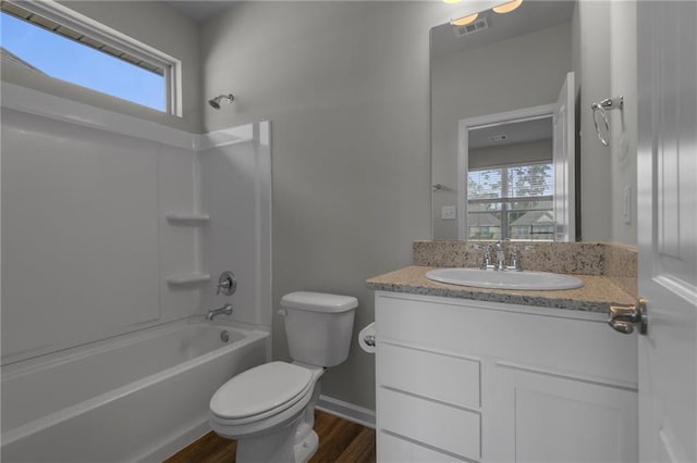 full bathroom featuring shower / tub combination, hardwood / wood-style floors, vanity, and toilet