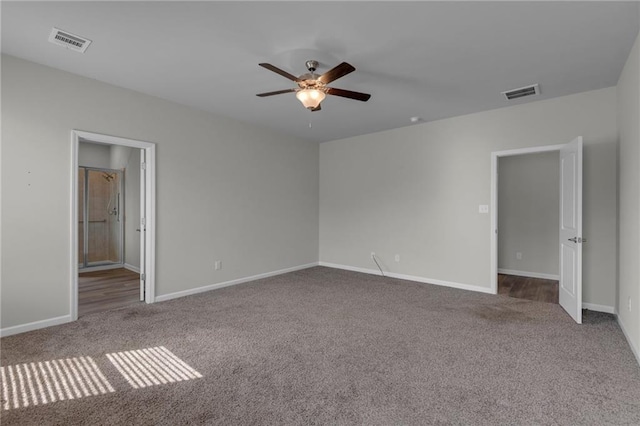 unfurnished bedroom with ceiling fan, ensuite bathroom, and light colored carpet