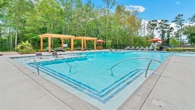 view of pool with a pergola and a patio