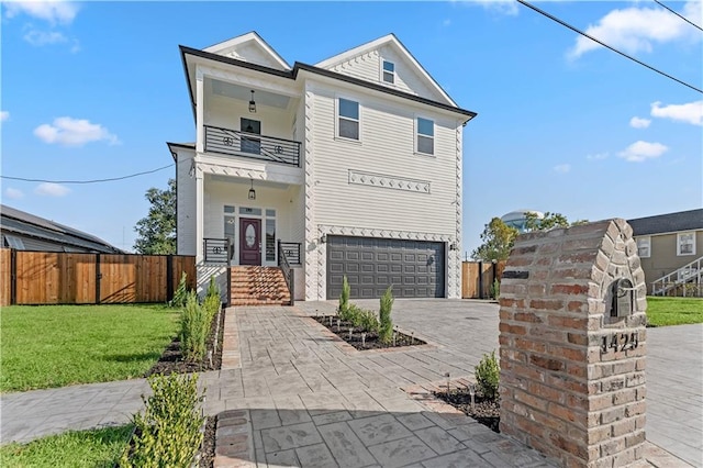 view of front of home featuring a balcony, a garage, and a front lawn