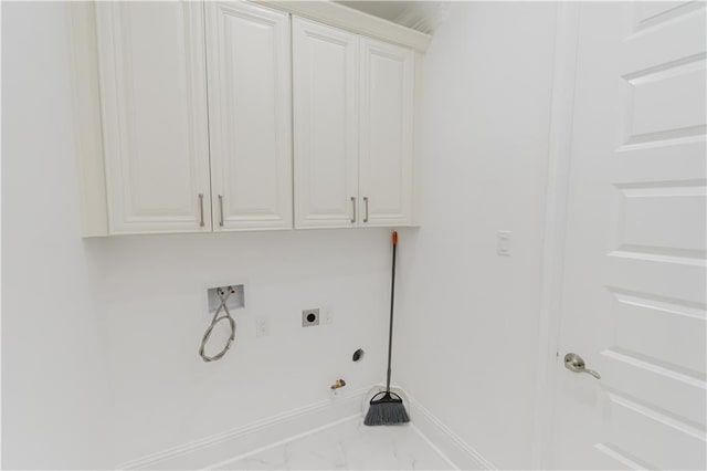 laundry room with hookup for an electric dryer, cabinets, and gas dryer hookup