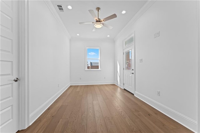 empty room with crown molding, hardwood / wood-style flooring, and ceiling fan