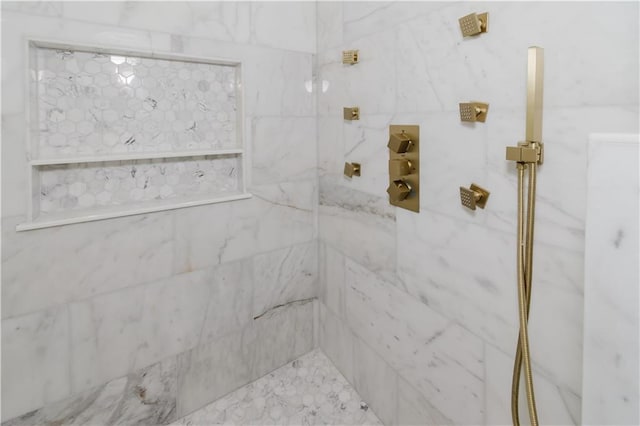 bathroom with a tile shower