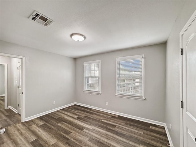 unfurnished bedroom with dark hardwood / wood-style floors