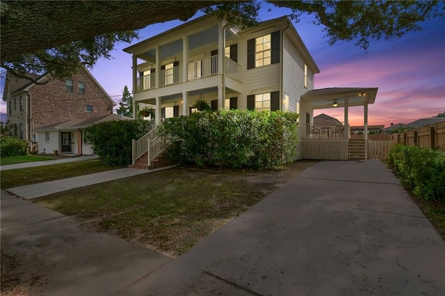 view of front of property featuring a balcony and a porch