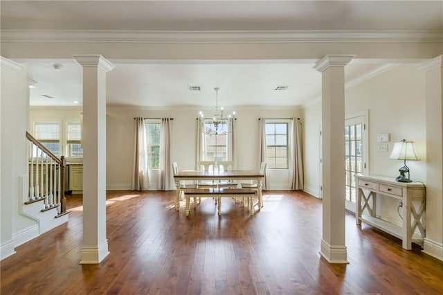 dining area with crown molding, a chandelier, and dark hardwood / wood-style flooring