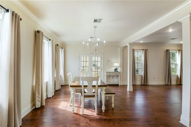 unfurnished dining area featuring crown molding, a notable chandelier, and dark wood-type flooring