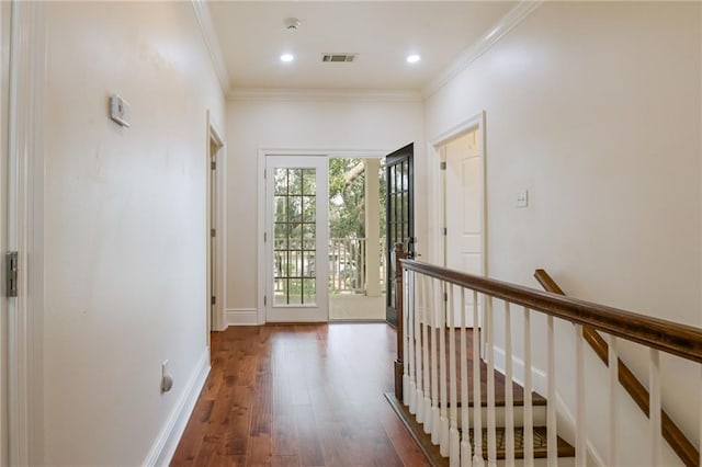 corridor featuring dark wood-type flooring and crown molding