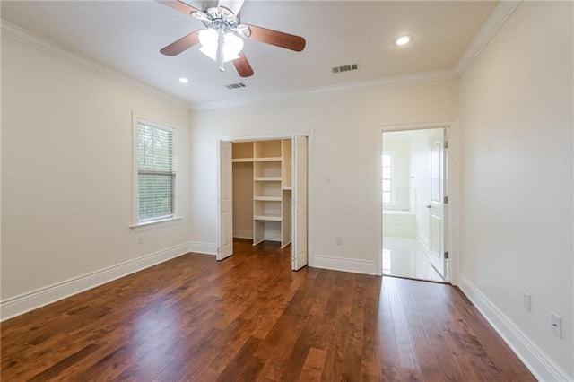 unfurnished bedroom featuring dark hardwood / wood-style flooring, ornamental molding, and ceiling fan