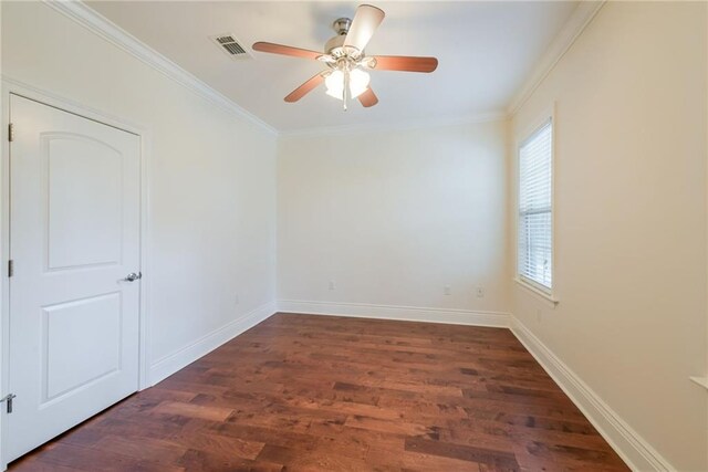 unfurnished room with a wealth of natural light, crown molding, dark hardwood / wood-style floors, and ceiling fan