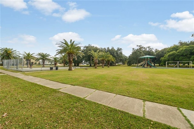 view of property's community featuring a playground and a yard