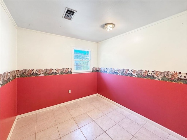 empty room featuring crown molding and tile patterned floors