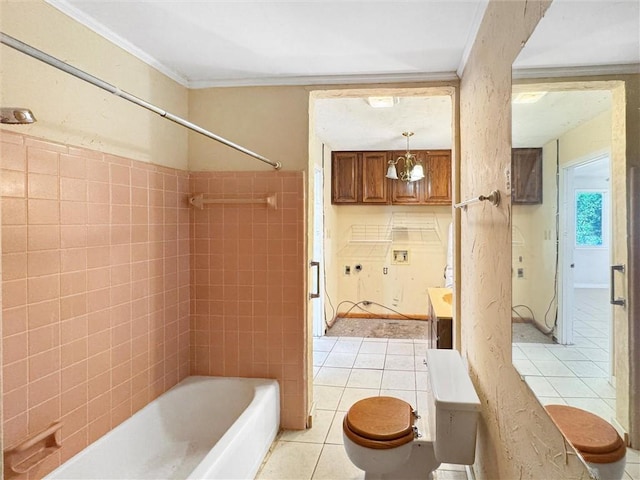 bathroom with ornamental molding, tiled shower / bath combo, toilet, and tile patterned flooring