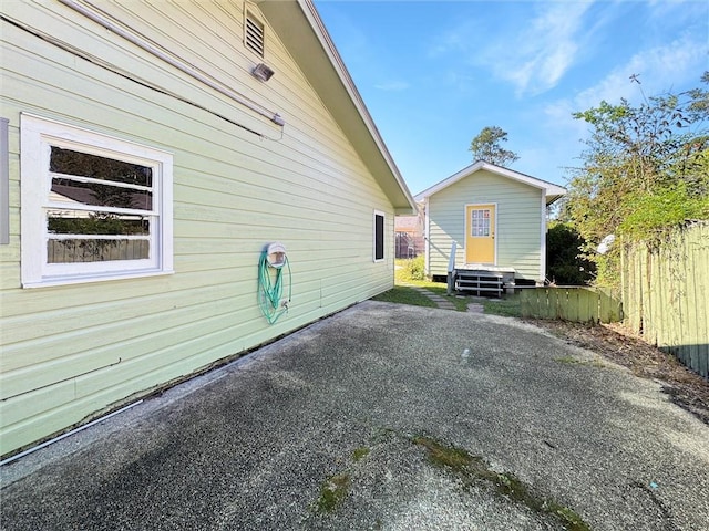 view of side of property featuring an outbuilding