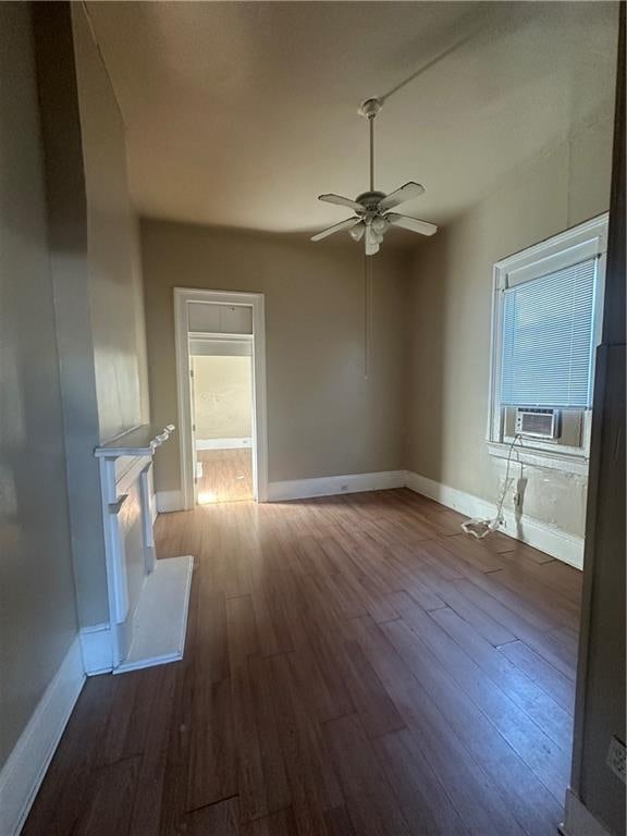 empty room featuring ceiling fan, wood-type flooring, and cooling unit