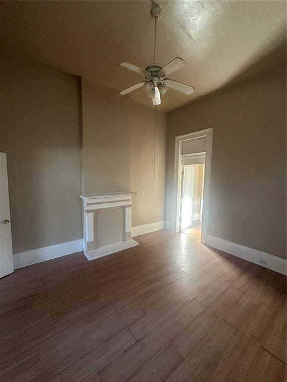 interior space featuring a textured ceiling, wood-type flooring, and ceiling fan