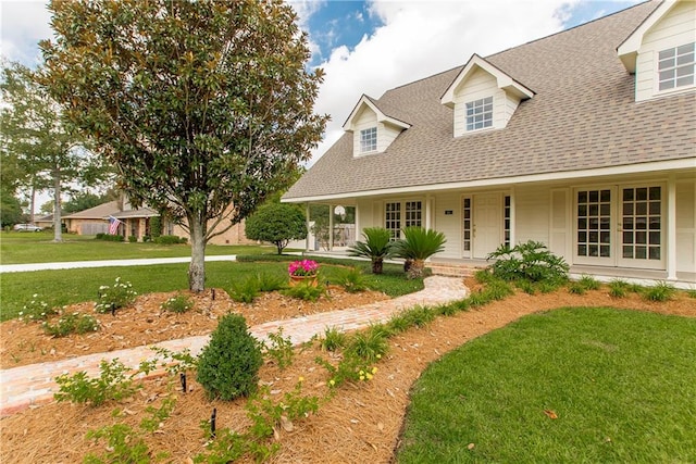 view of front of house with a front yard and covered porch