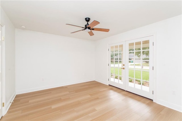 empty room with french doors, ceiling fan, and light wood-type flooring