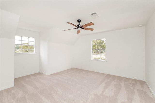 empty room with a wealth of natural light and light colored carpet