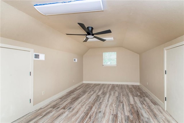 bonus room with light hardwood / wood-style flooring, lofted ceiling, and ceiling fan