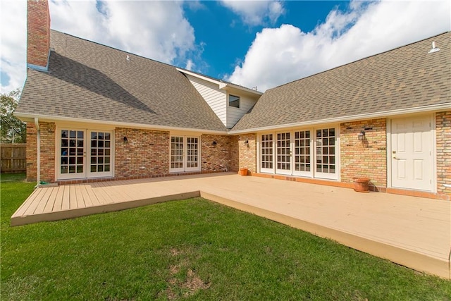 back of property featuring a patio area and a lawn