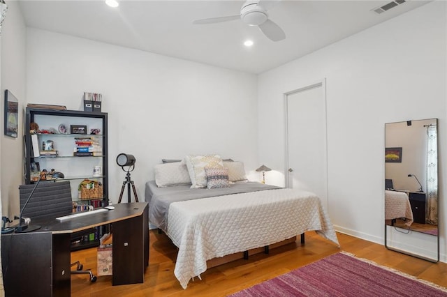 bedroom with hardwood / wood-style floors and ceiling fan