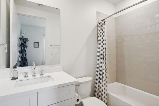 full bathroom featuring shower / bath combo, vanity, and toilet