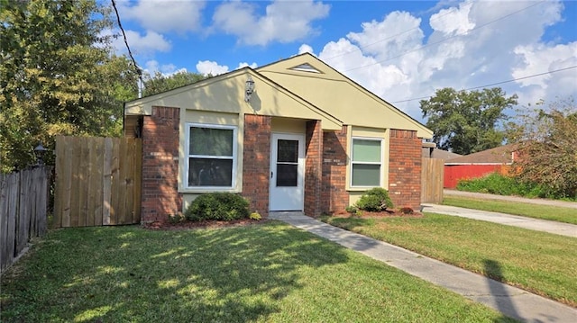 bungalow-style home featuring a front lawn