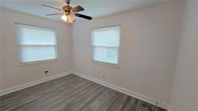 empty room with ceiling fan, dark hardwood / wood-style flooring, and a healthy amount of sunlight