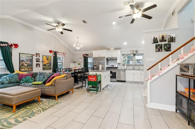 living room featuring ornamental molding, a healthy amount of sunlight, and vaulted ceiling