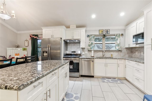 kitchen featuring pendant lighting, sink, white cabinets, and stainless steel appliances