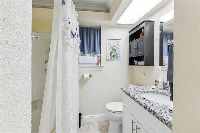 bathroom featuring vanity, a shower with shower curtain, ornamental molding, and toilet