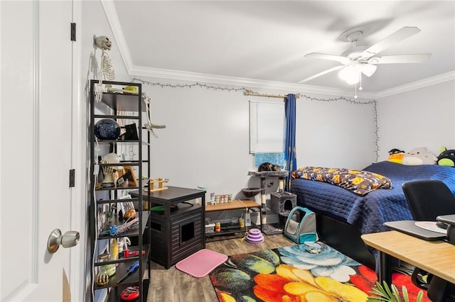 bedroom with ornamental molding, hardwood / wood-style flooring, and ceiling fan