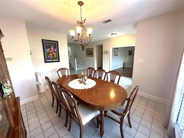 dining room featuring light tile patterned flooring and an inviting chandelier