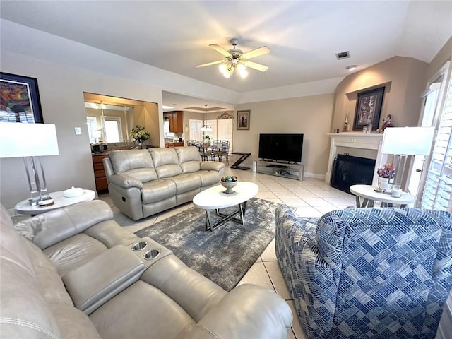 living room with ceiling fan and light tile patterned floors