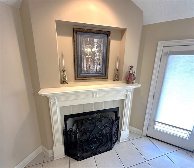 interior details featuring a fireplace and tile patterned flooring